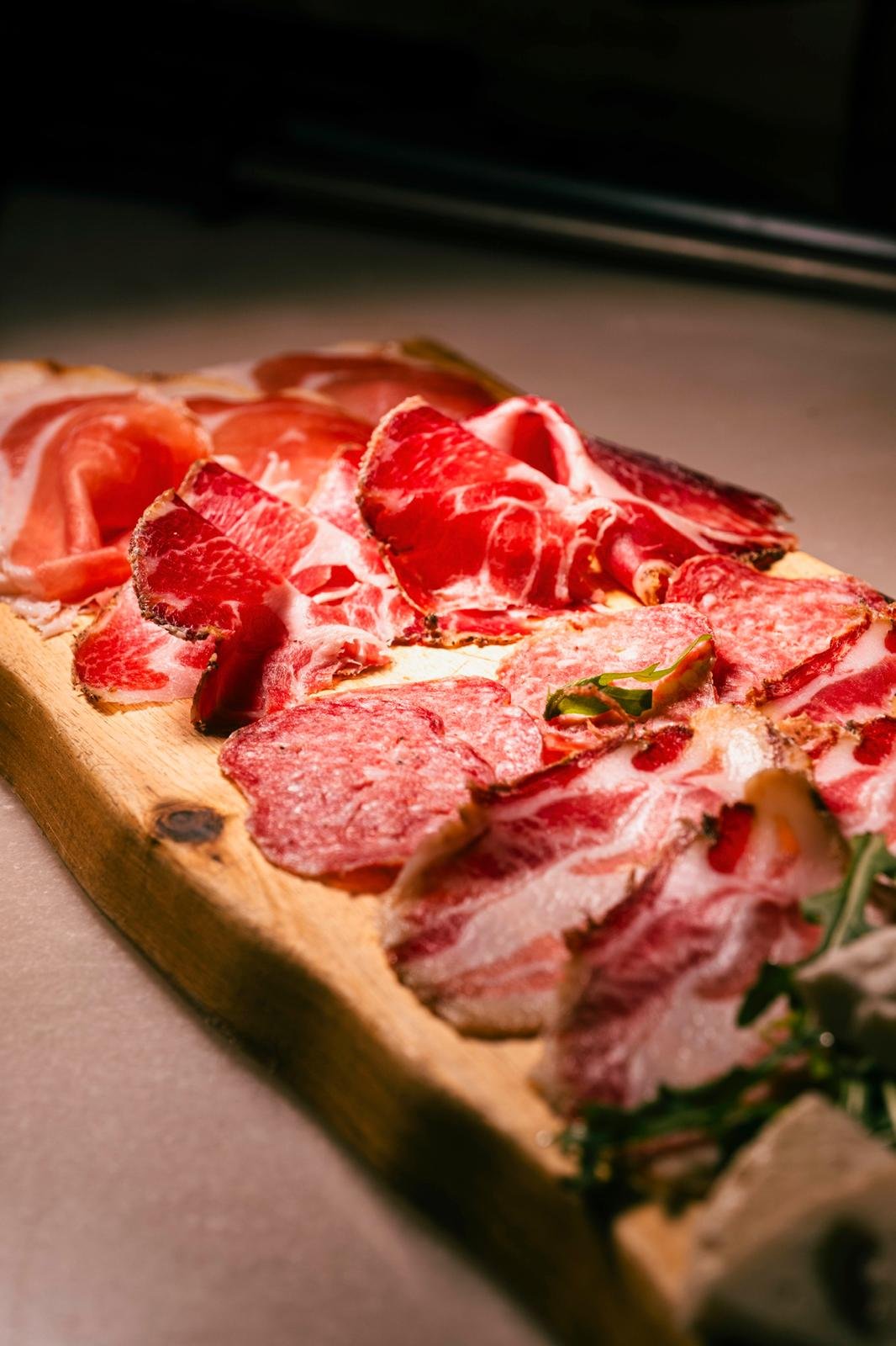 Selezione di salumi affettati su un tagliere rustico